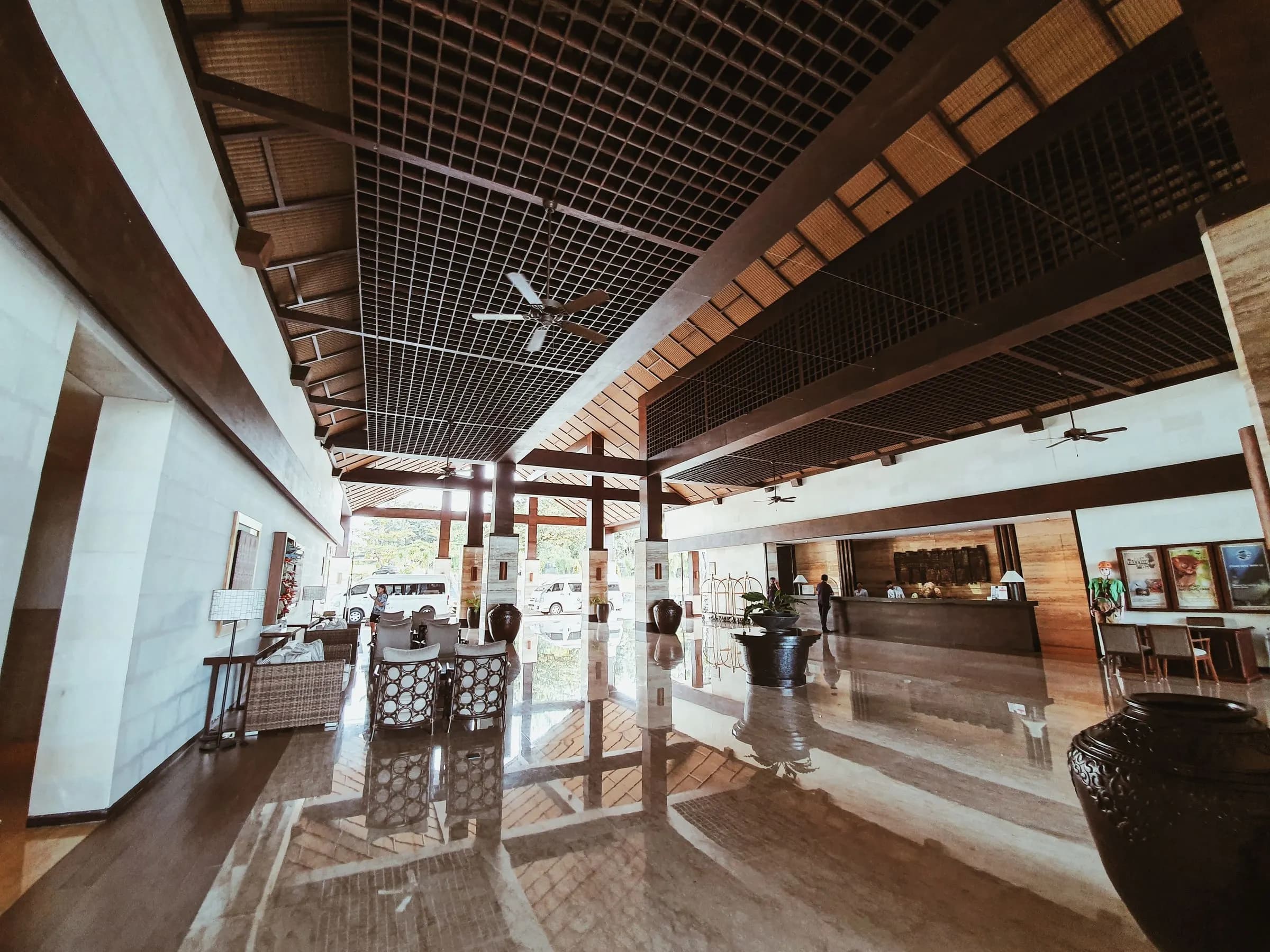Open-air resort lobby with timber ceiling